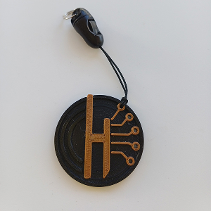 Porte-clés rond, noir avec le logo Halimagination, et sa dragonne